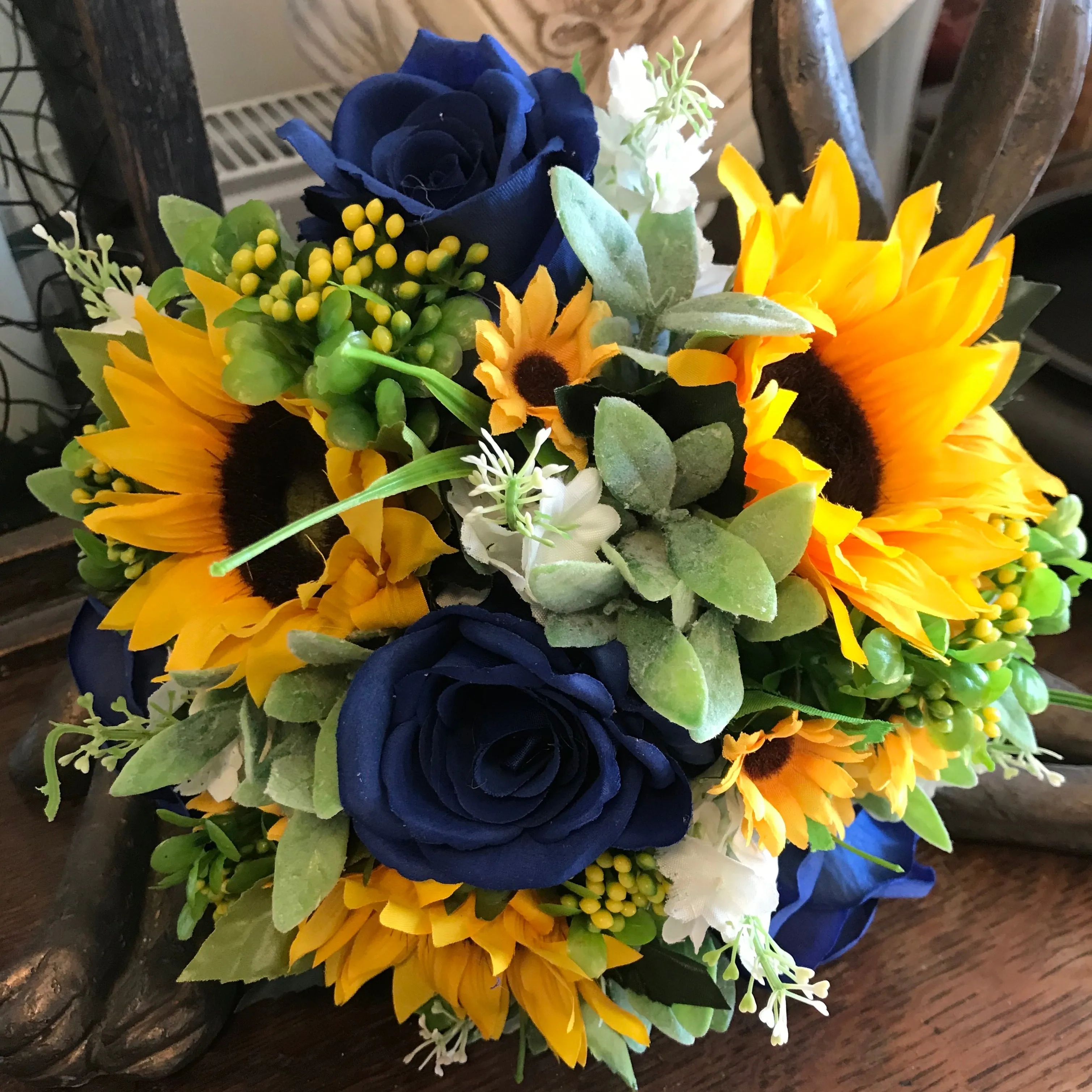 A collection of wedding bouquets featuring  sunflowers and either royal or navy blue roses